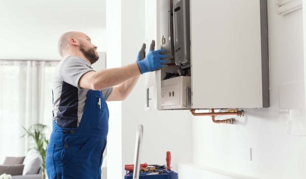 Professional engineer doing a boiler inspection at home